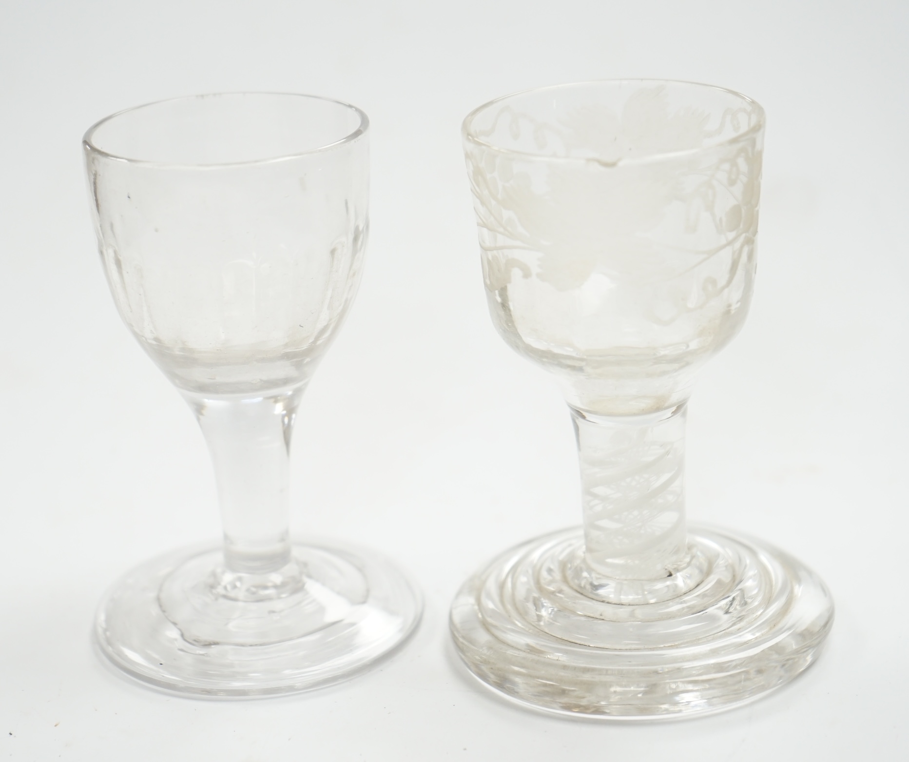 A mid 18th century firing glass with double series opaque twist stem and terraced foot, and another glass, tallest 9.5cm high. Condition - good